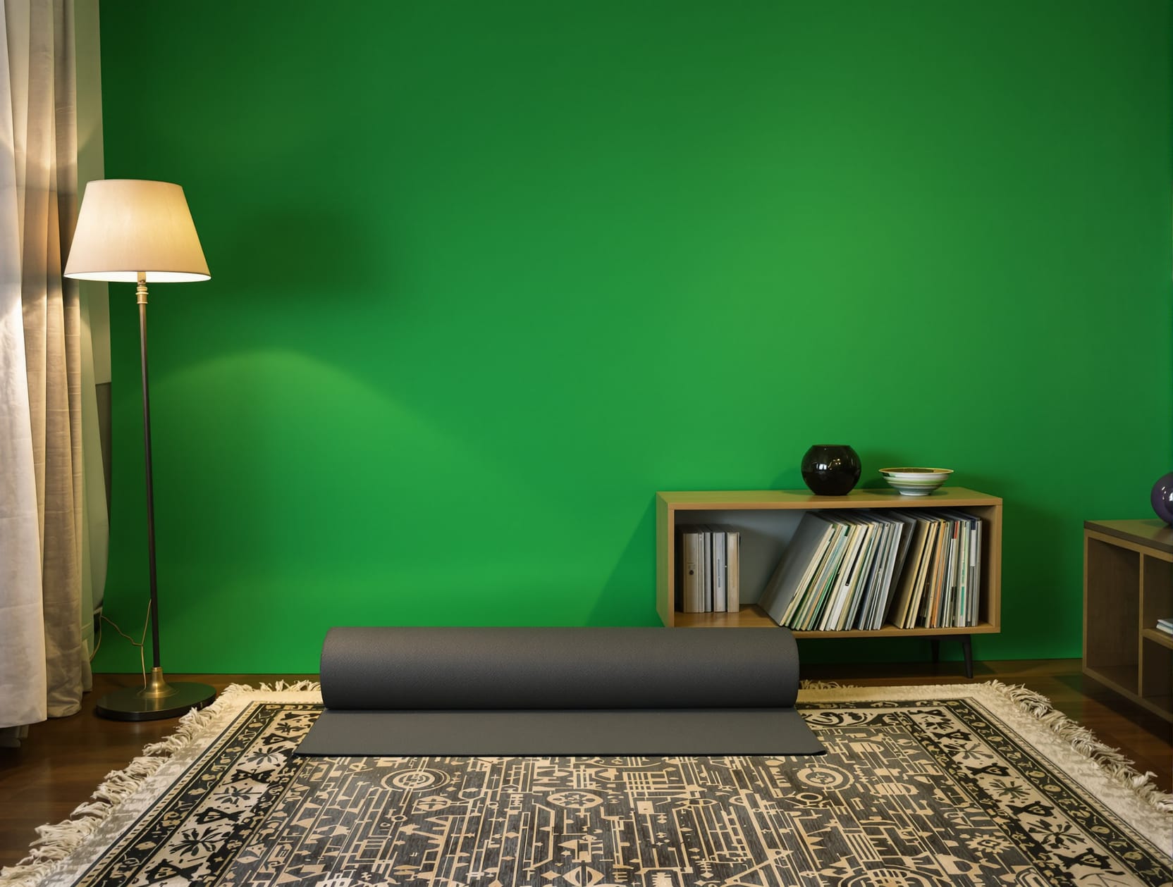 In the same small apartment living room, a rolled charcoal exercise mat leaning against a low wooden shelf of vinyl reco