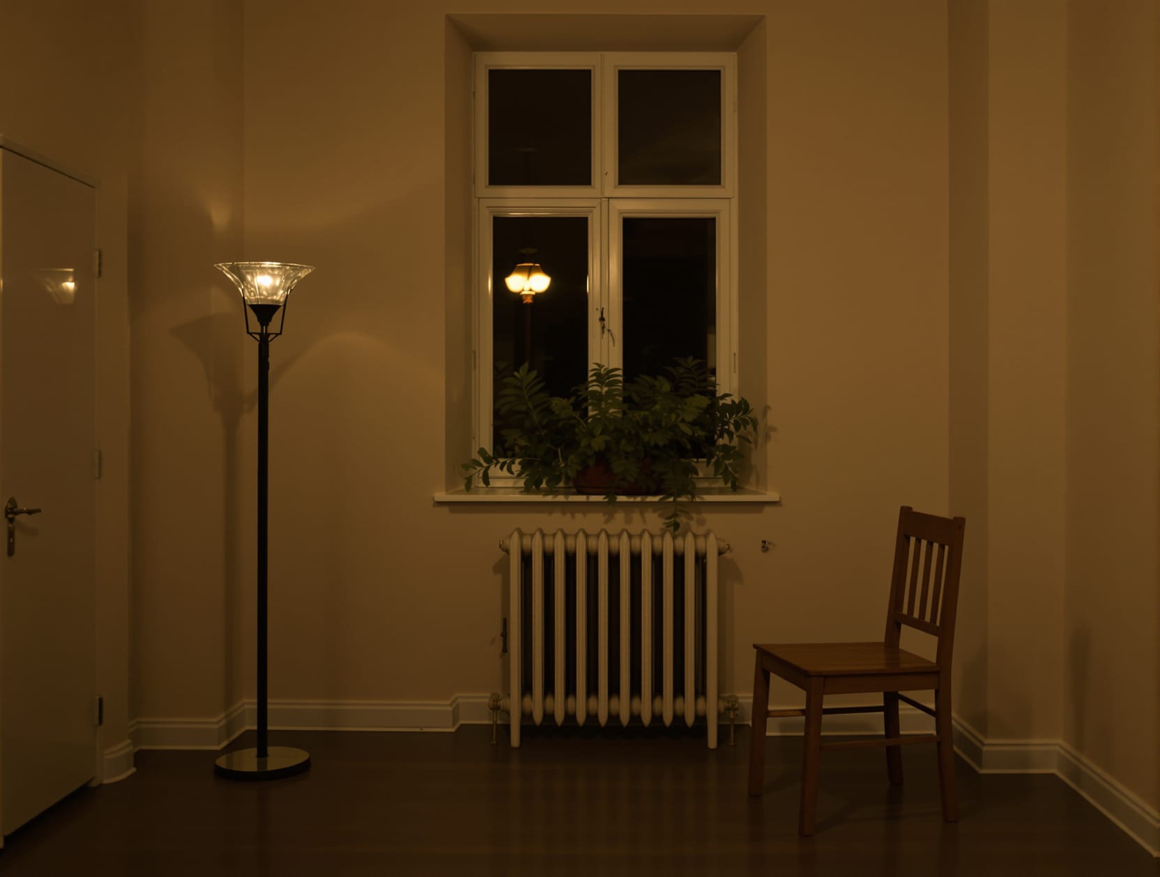 The same small apartment living room at night, a plain wooden dining chair turned toward a dark window with an old cast-